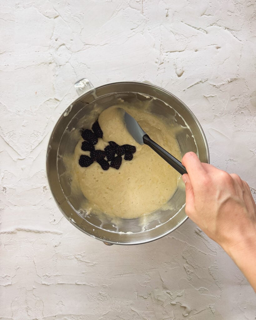 folding in the blackberries into the batter
