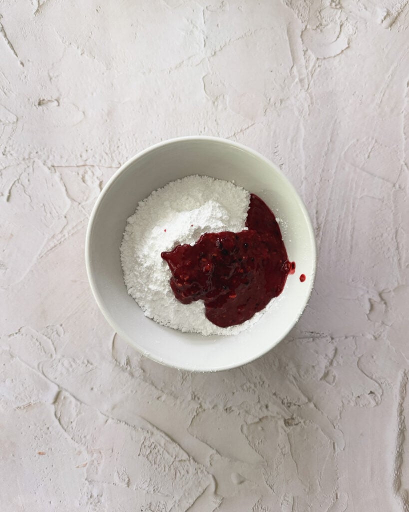 pureed blackberries ready to be mixed with the powdered sugar for the drizzle