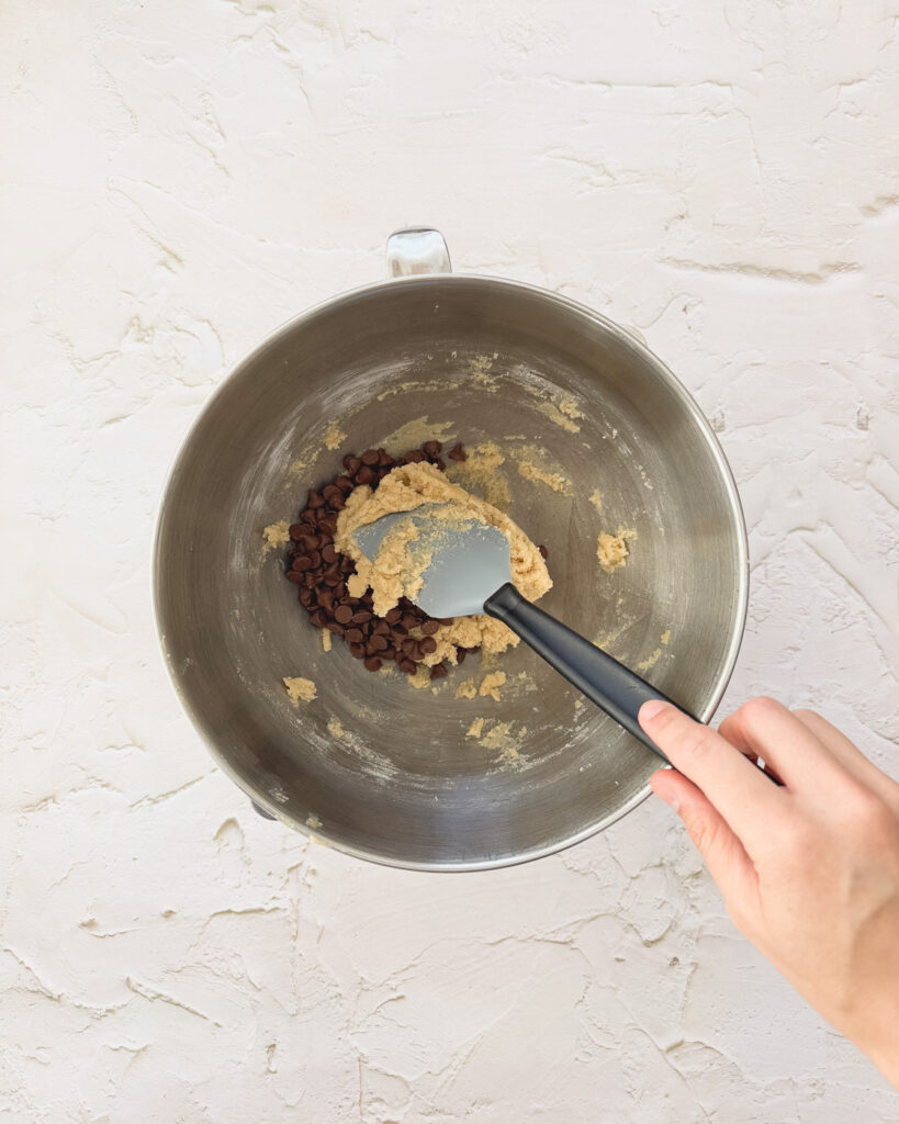 Folding in chocolate chips to cookie dough