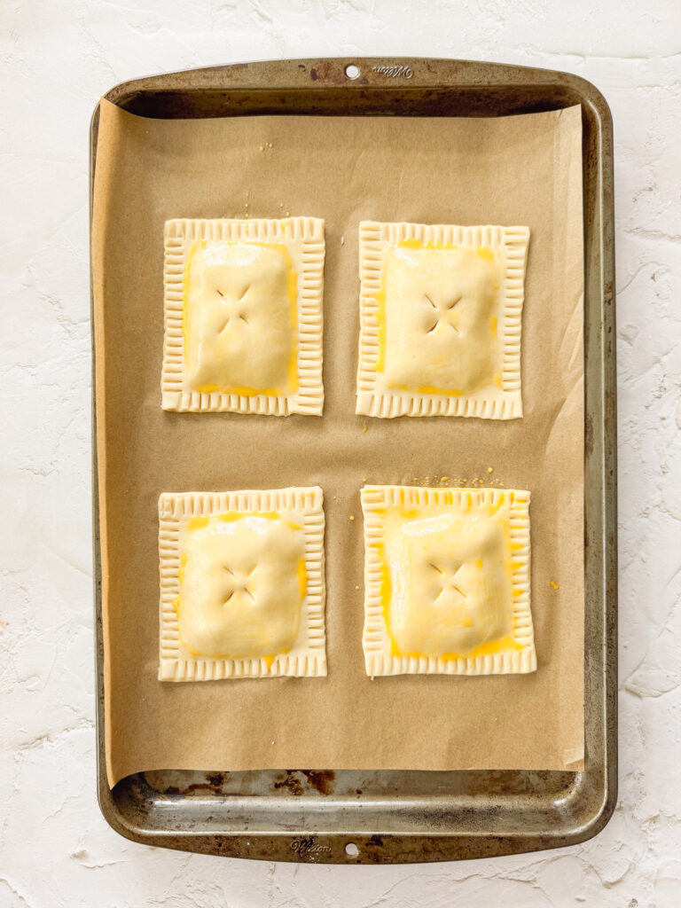 Pastries brushed with egg wash ready to bake