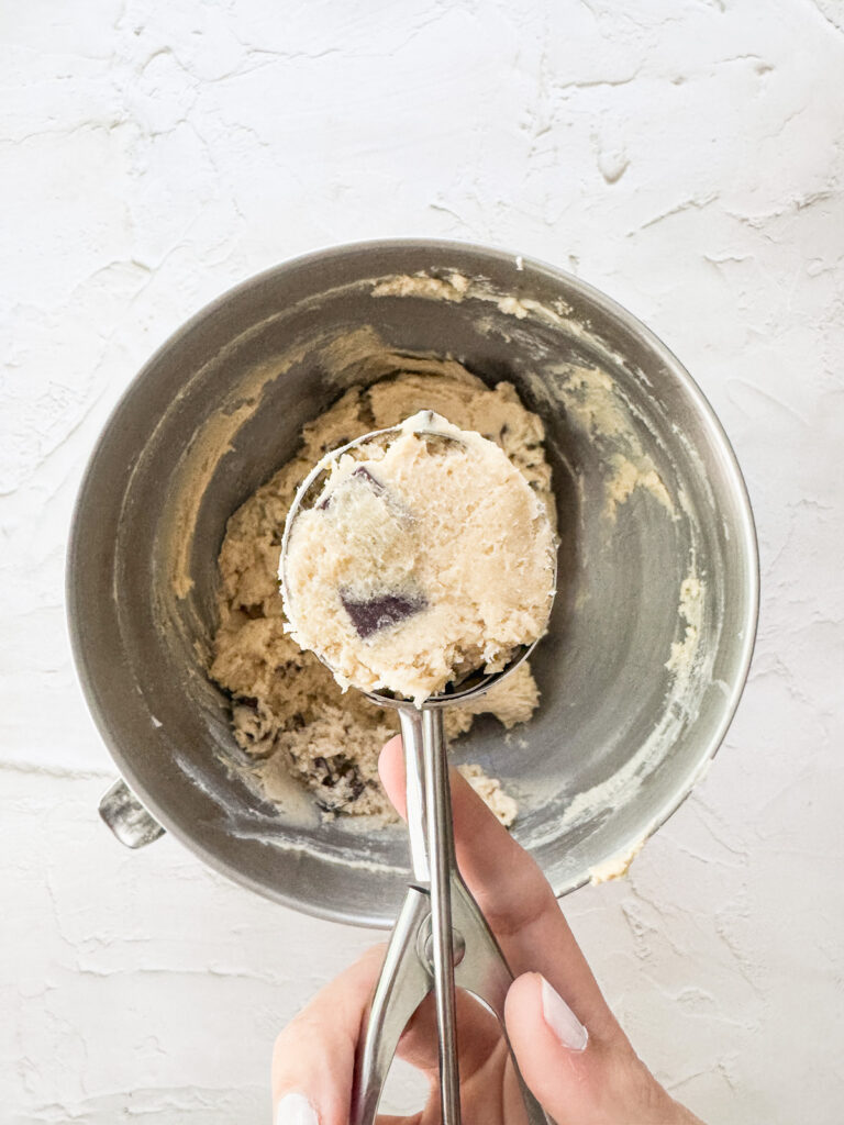Portioning 3 tablespoons of cookie dough per cookie