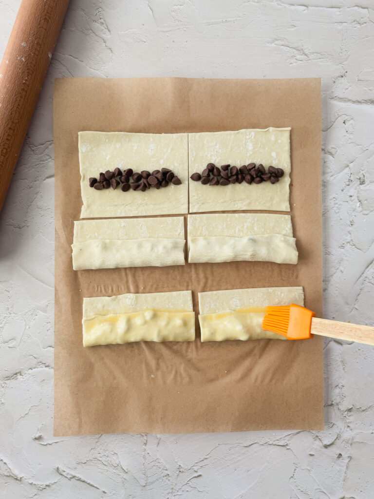 Fill the dough with chocolate chips and make the first fold